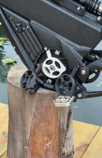 A white motor cover for a Talaria x3 electric bike emoto, mounted and installed on the bike's motor area, with visible bolts and mounting hardware.